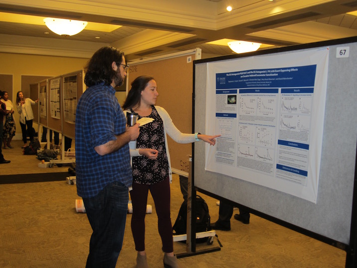 Students explaining their research for their symposium projects. 
