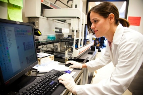 woman typing on a computer in a lab